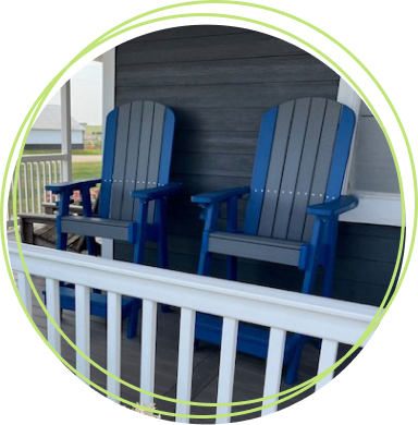 2 blue and gray bar-height composite lumber chairs on front porch